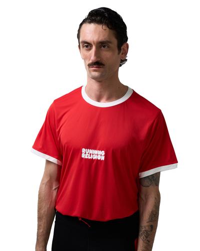 A man with a moustache wearing a red T-shirt with white trim and a small white Running Religion logo on the chest.