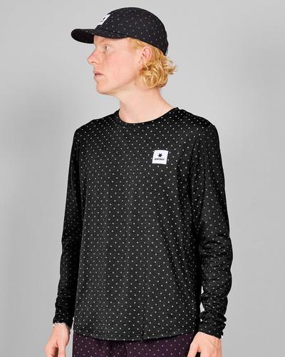 A man in a black cap wearing a black long-sleeve running top covered in small reflective white dots.