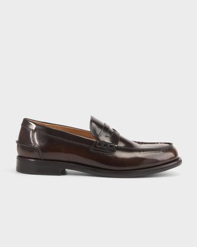 Side view of a glossy dark brown-burgundy leather Vagabond Steven penny loafer on a light grey background.